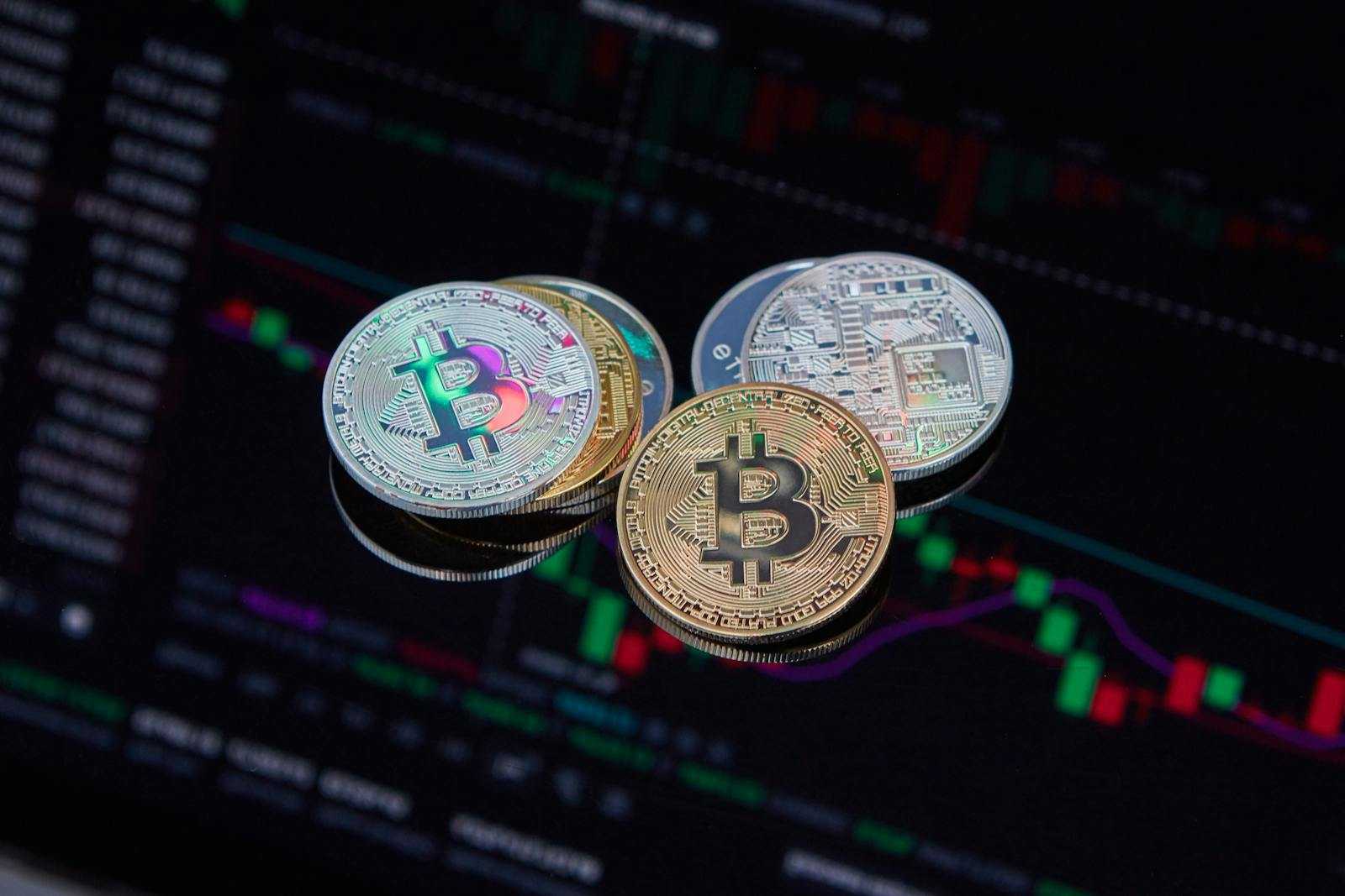 Close-up of Bitcoin cryptocurrency coins with a digital market chart background, symbolizing finance and technology trends.